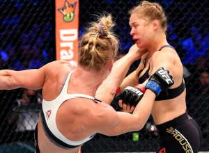 US Mixed Martial Arts (MMA) fighter Ronda Rousey hugs Gina Carano after defeating her during thei...