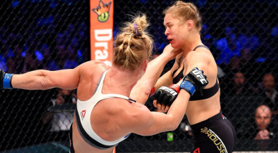 US Mixed Martial Arts (MMA) fighter Ronda Rousey hugs Gina Carano after defeating her during thei...